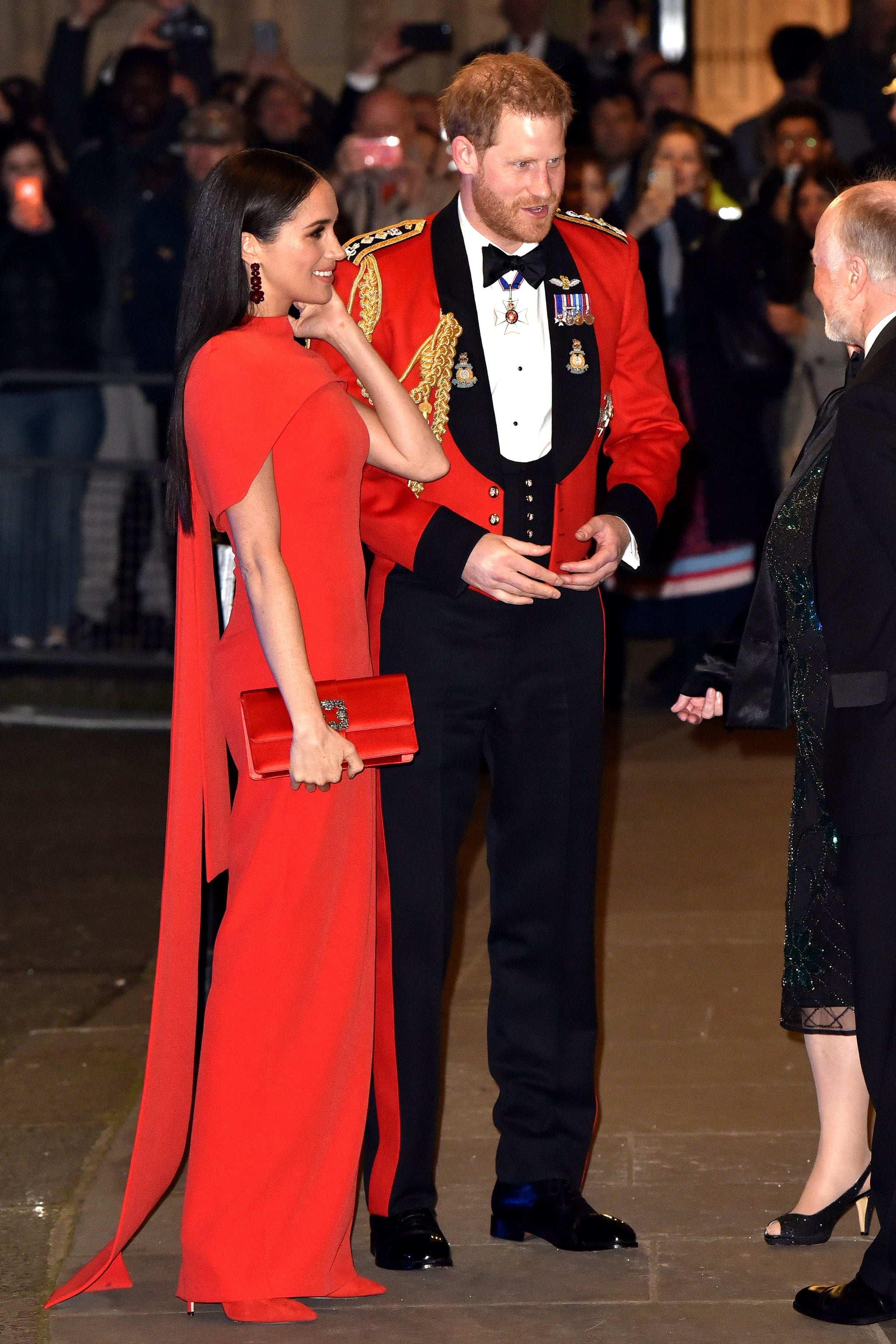 Meghan Markle At The Mountbatten Festival Of Music Meghan Markle Color Coordinates With Prince Harry In A Red Safiyaa Cape Dress Popsugar Fashion Photo 14