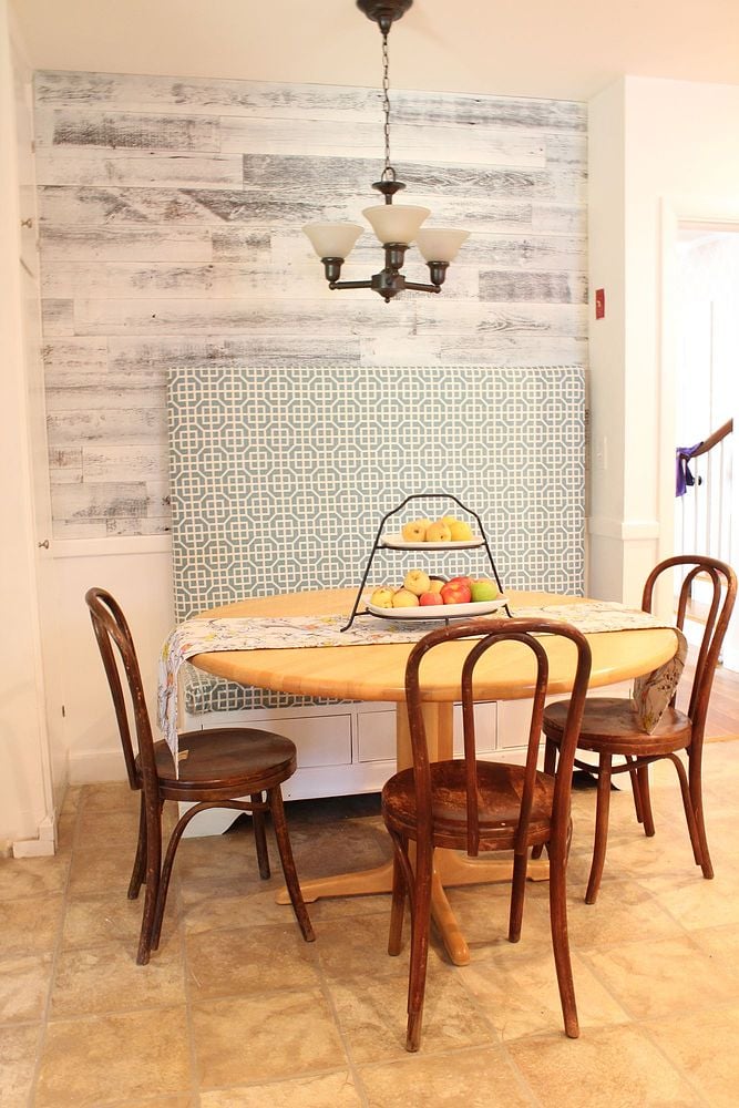 A boring kitchen corner is transformed into a charming, diner-inspired space with the addition of white-and-gray planks above the wainscoting.