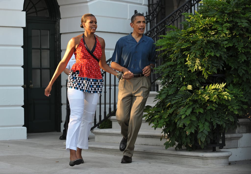 In 2010, Michelle and Barack hustled hand in hand to greet families at that year's barbecue.