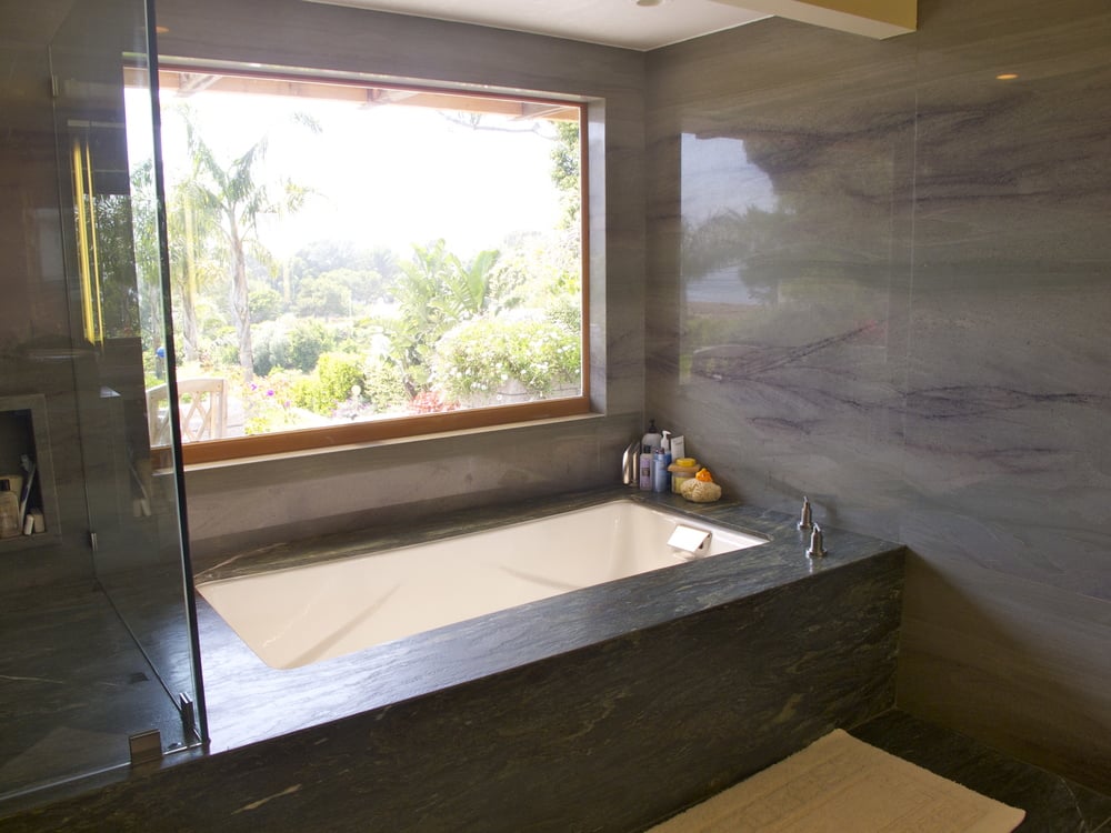 One of the home's three bathrooms is lined with luxe natural stone.