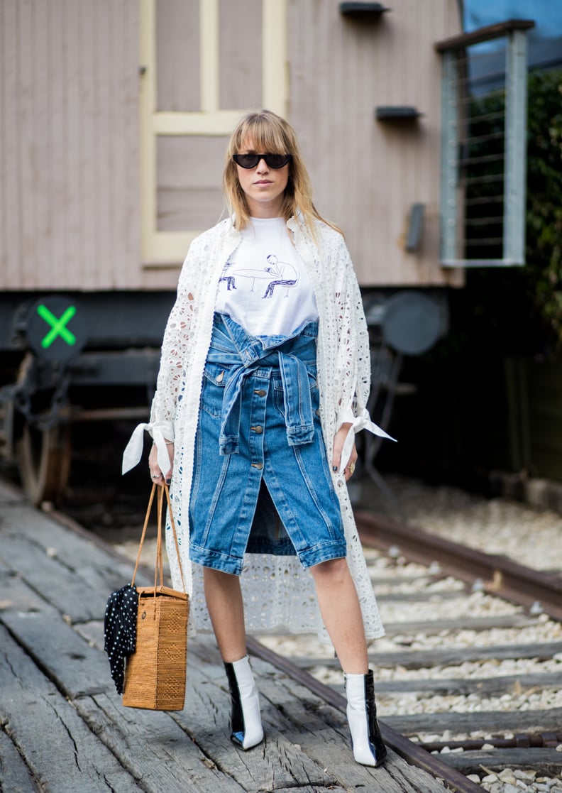 Throw a Knee-Length Eyelet Coat Over a White Tee and Denim Skirt