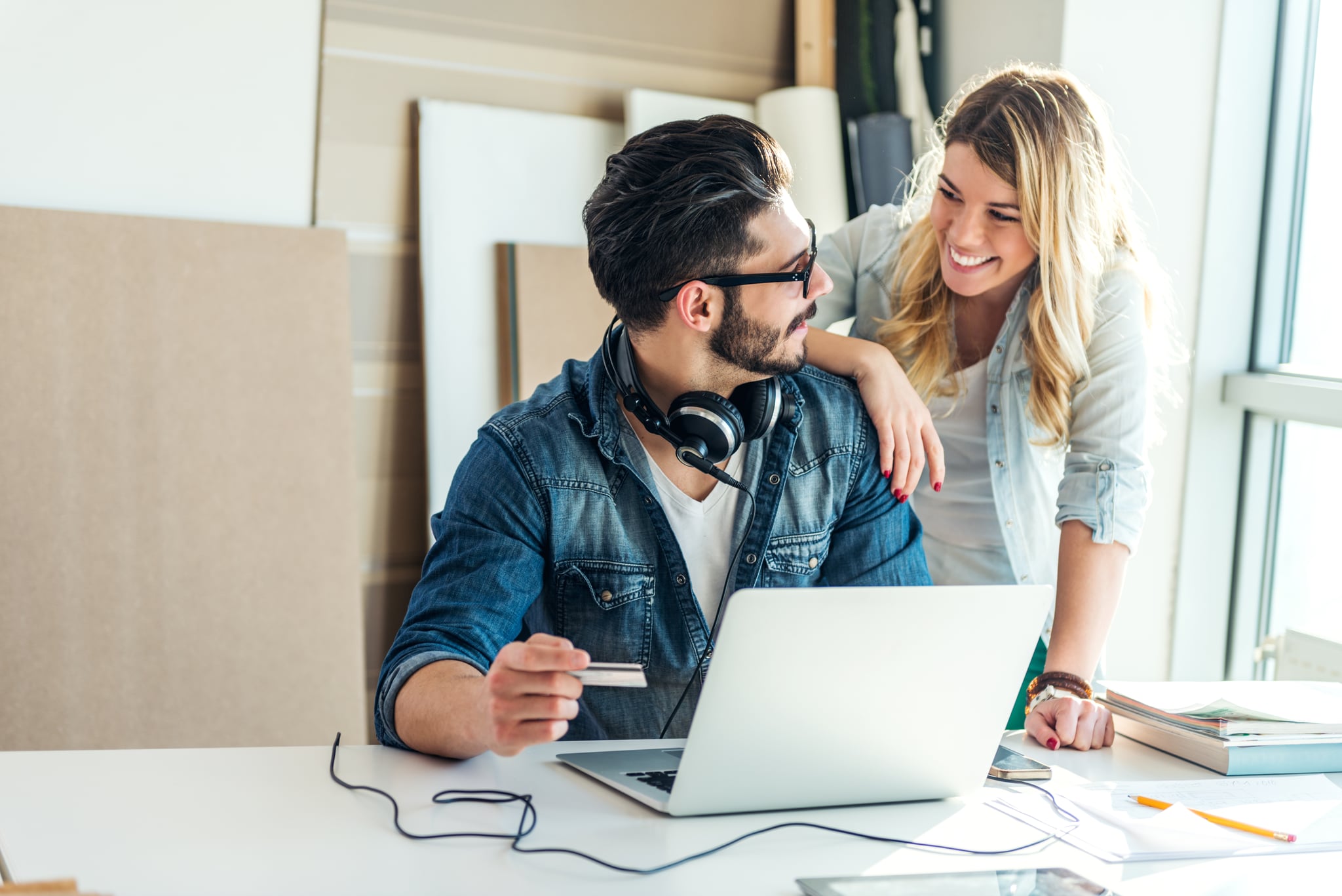 Happy couple shopping online on a computer.