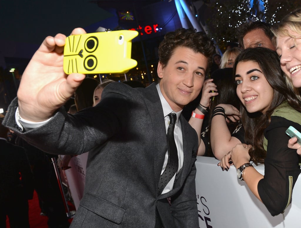 Miles Teller grabbed a cat-covered phone for a fan selfie.
