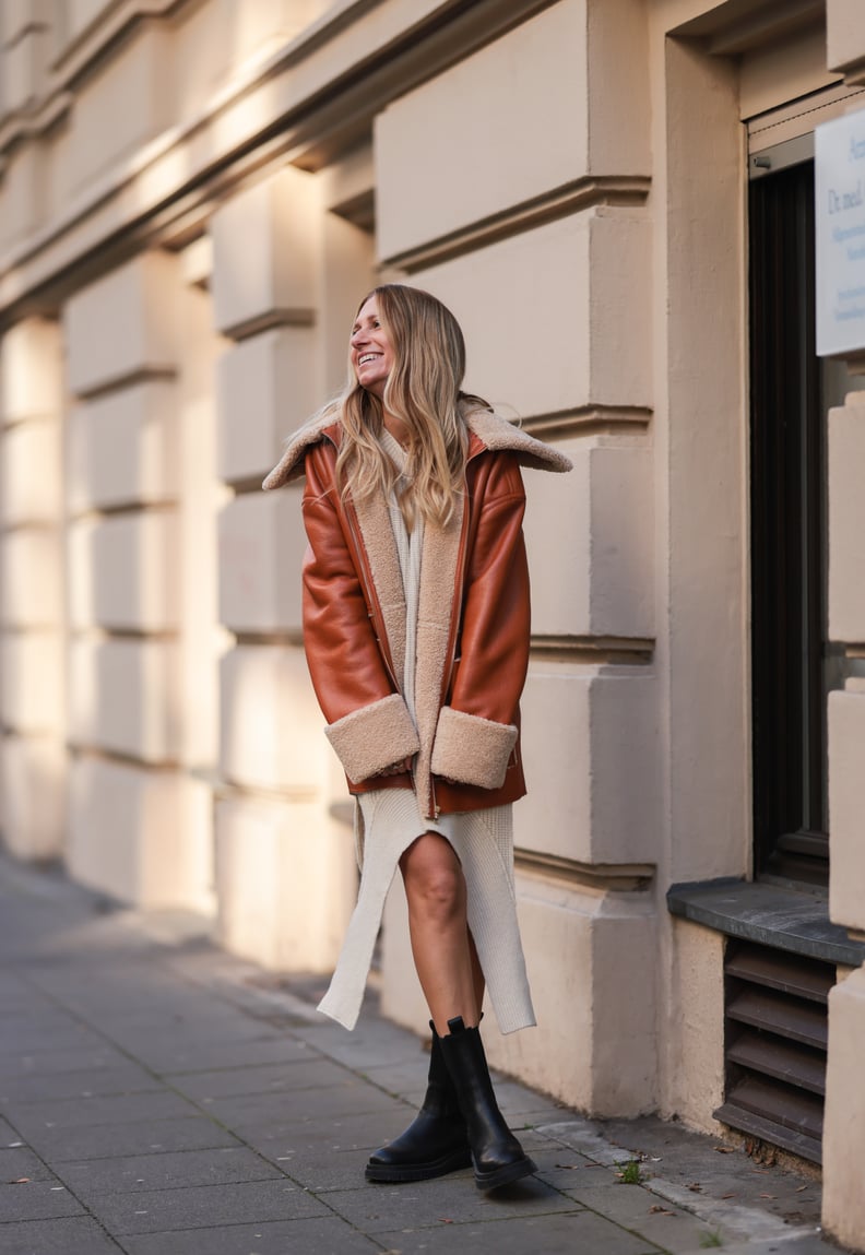 Stay Cozy With a Shearling Leather Coat Worn Over a Knit Dress