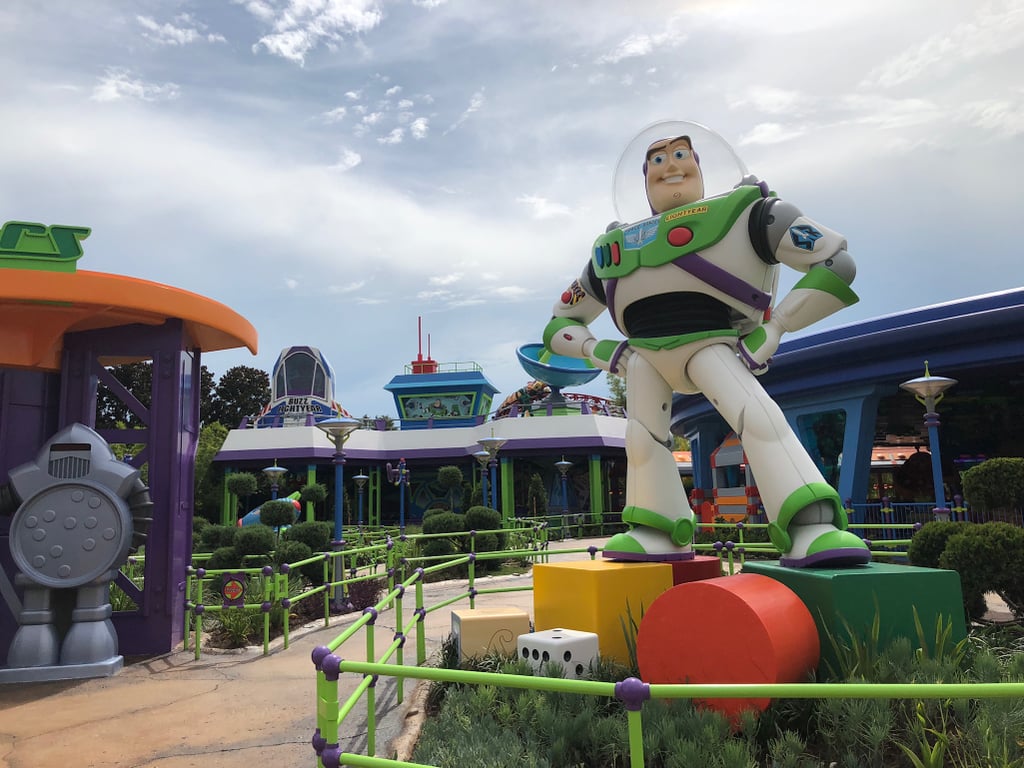 Take a photo in front of Buzz Lightyear at the entrance of Alien Swirling Saucers.