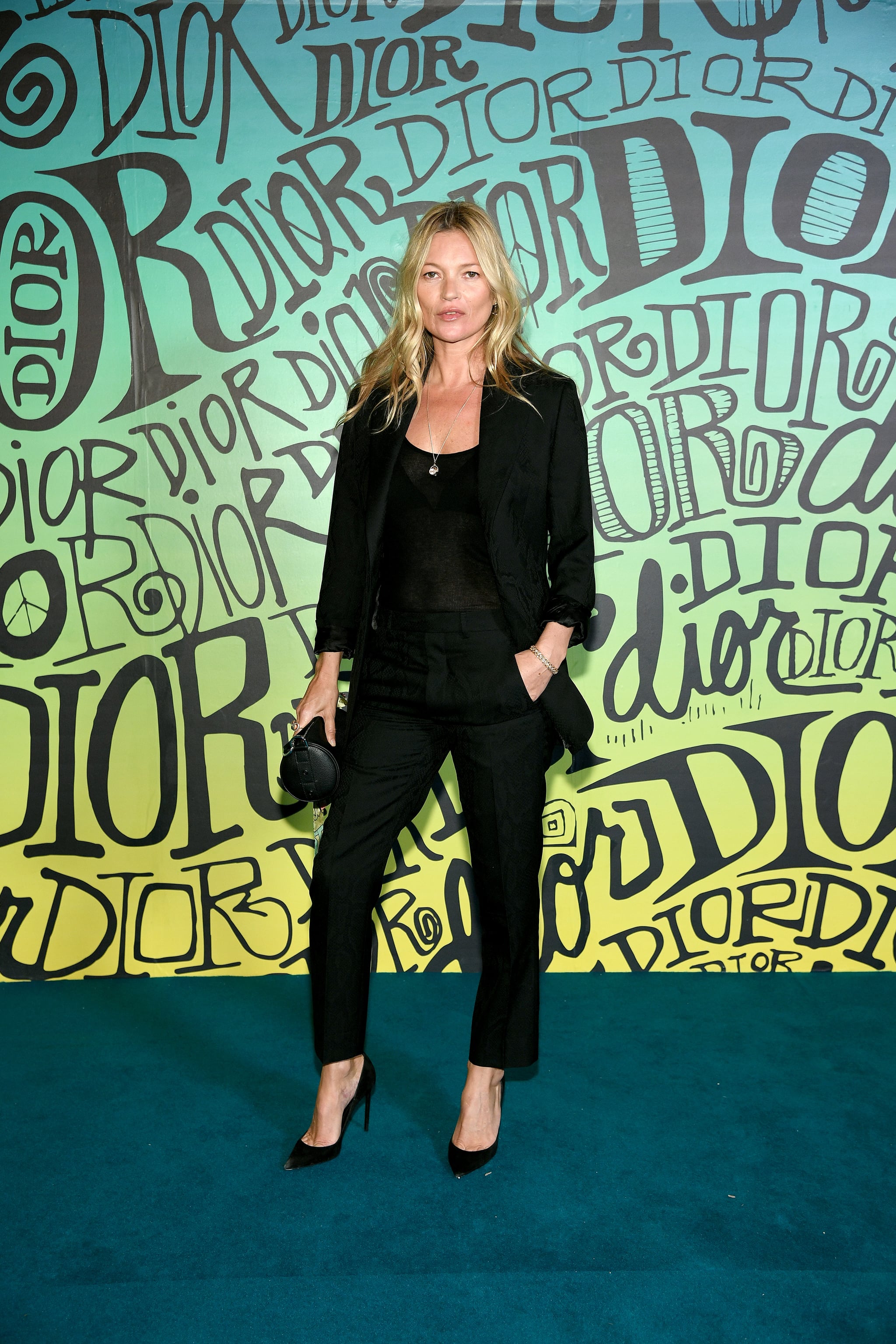 Moss attends the Dior men's Autumn 2020 catwalk show in her signature, smart black suit.