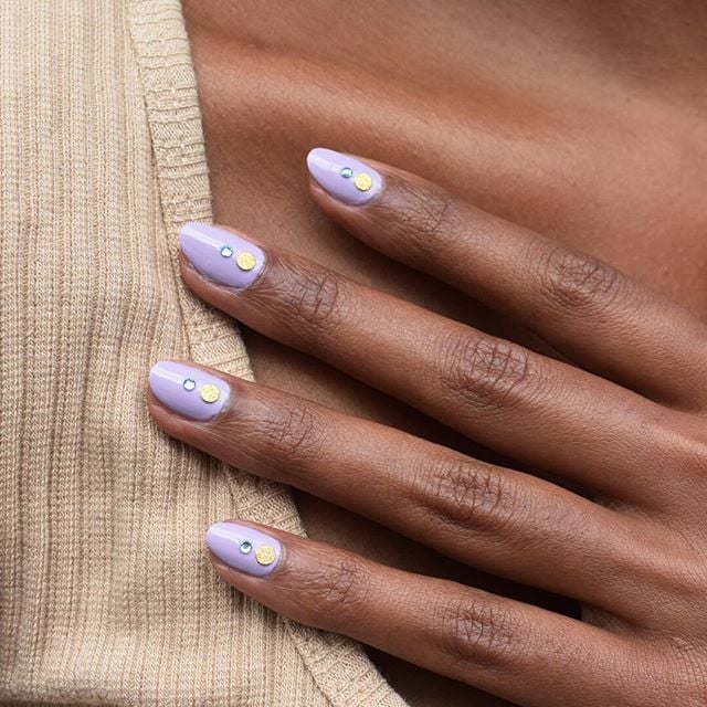 Your memory of using nail stickers and decals might reach as far back as your middle school sleepover days. Don't worry, this trend isn't that. These nail embellishments are cooler, more elevated, and the stuff of Instagram gold. To execute the "tonal studs" nail art trend, you'll need your most prismatic pearls or gems, and, of course, your favorite nail polish color.
Chief Creative Officer of NYC salon Paintbox Eleanor Langston previously told POPSUGAR that she predicts that the look will be everywhere this Fall. "Adding a tonal stud is easy to do and looks modern and subtle," she said. "It adds chic interest to your nails." 
Lady Gaga kicked off the trend with her pearl-encrusted manicure created by Miho Okawara, which she debuted on Instagram, and we're certain we'll see more A-listers try it out in the cooler months. In the meantime, check out the most eye-catching "tonal studs" nail art looks on the Internet, ahead.