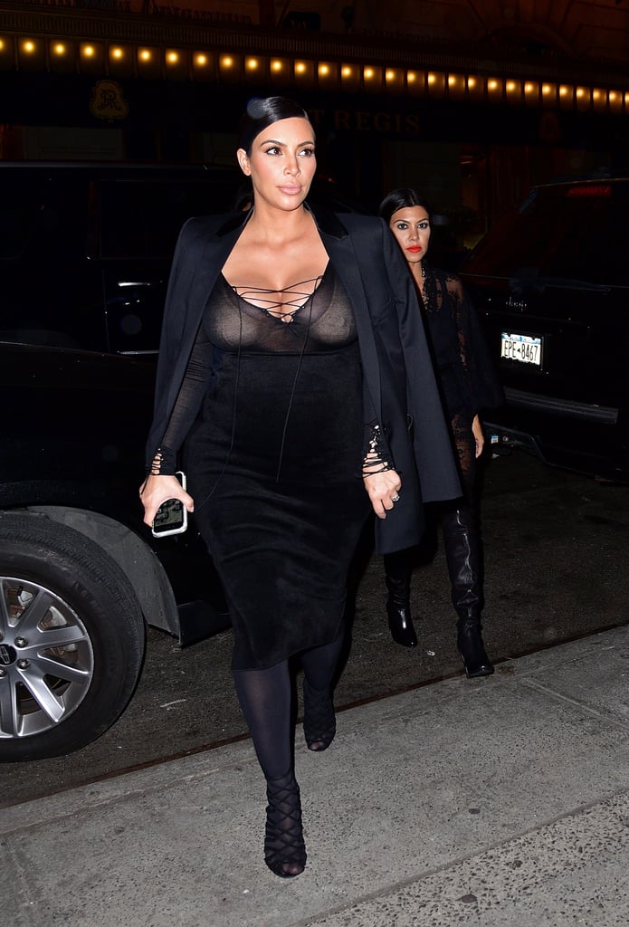 Kim stepped out with Kourtney wearing her sheer lace-up top, a black high-waisted skirt, and strappy heels. She added a sleek blazer and opaque tights to keep warm.
