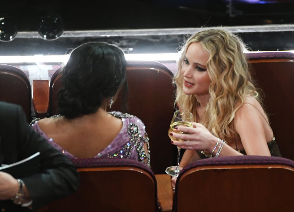 Jennifer Lawrence, wine in hand, chatted with Salma Hayek.