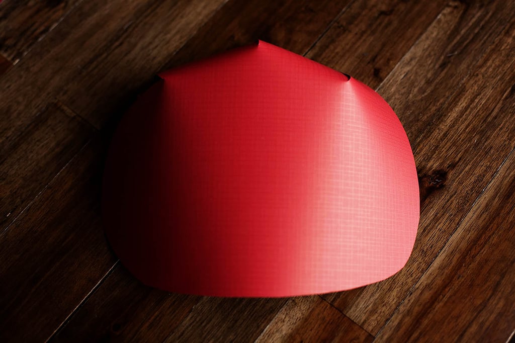 Use this template to cut a mask out of red paper. I made mine a bit larger than the template I printed. Fold and secure with glue.
