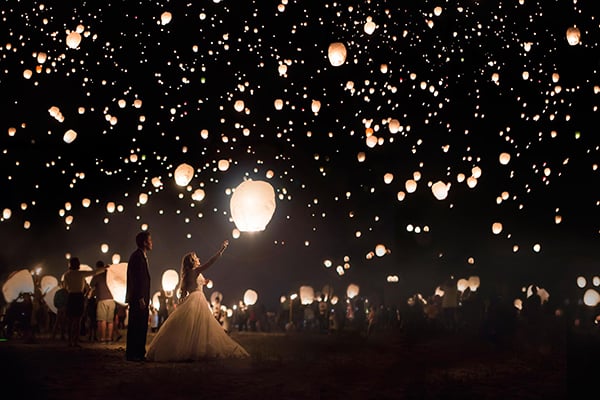 Light up the night sky with a lantern release. | Over-the-Top Wedding