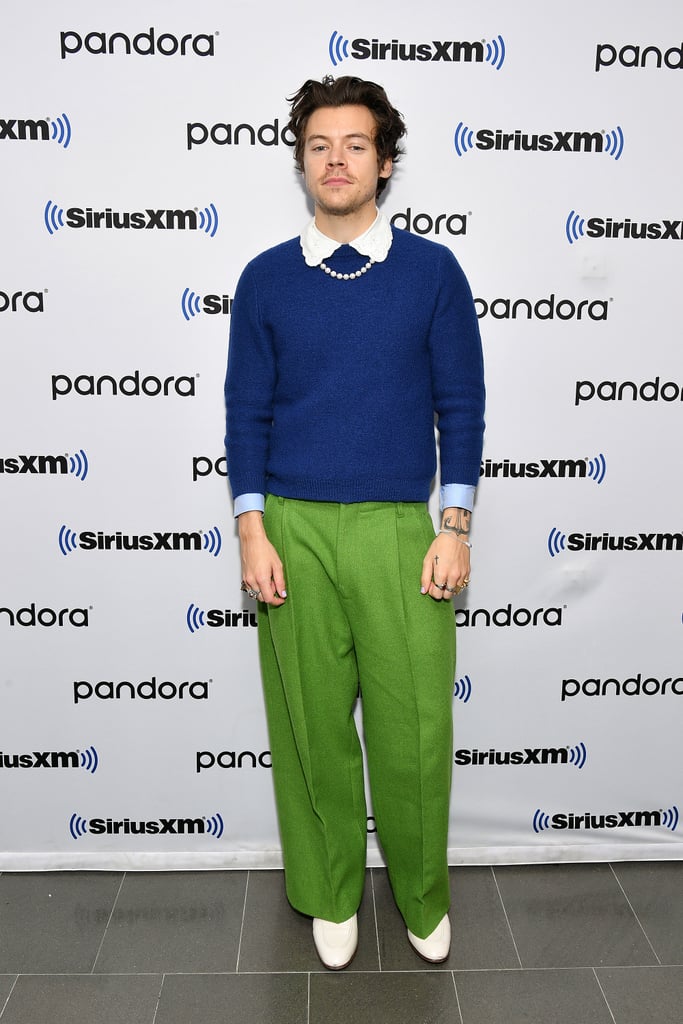 Wearing a blue sweater, green trousers, a pearl necklace, and white boots to an event in 2020.