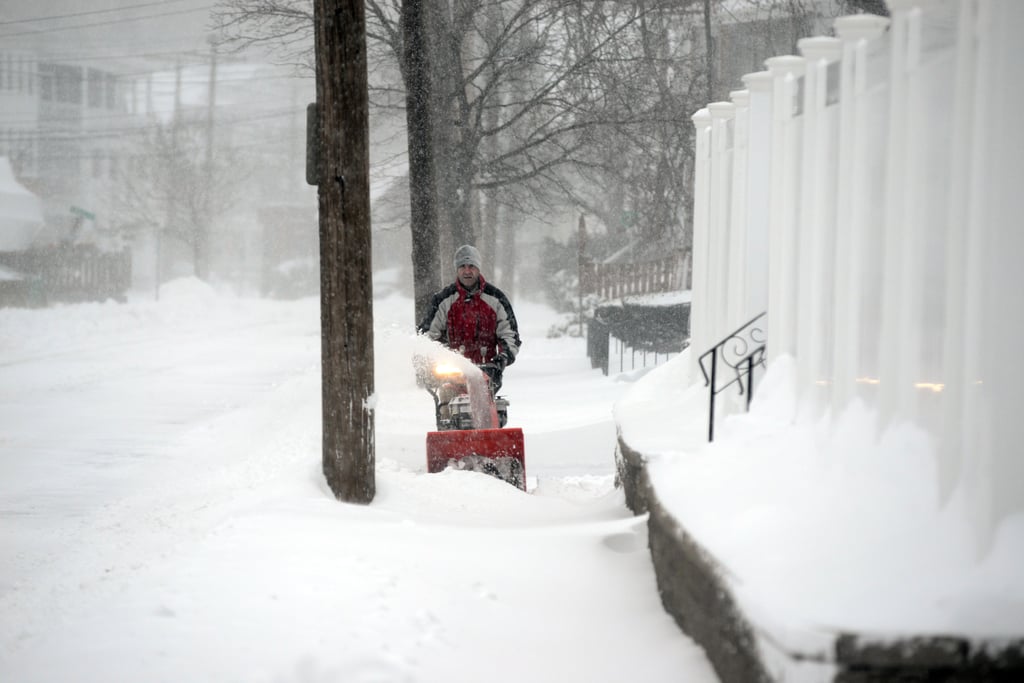 After the overnight storm in Winthrop, MA, a man took to the sidewalk with his snowblower. The nearby city of Boston expected 10 to 19 inches by Friday night, just over 24 hours into the storm.