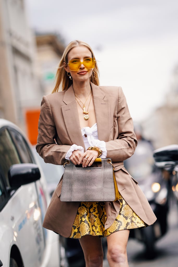 A neutral blazer tempers a printed miniskirt for smart occasions.