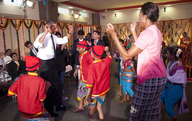 Dancing with children during an official visit to India in 2010.