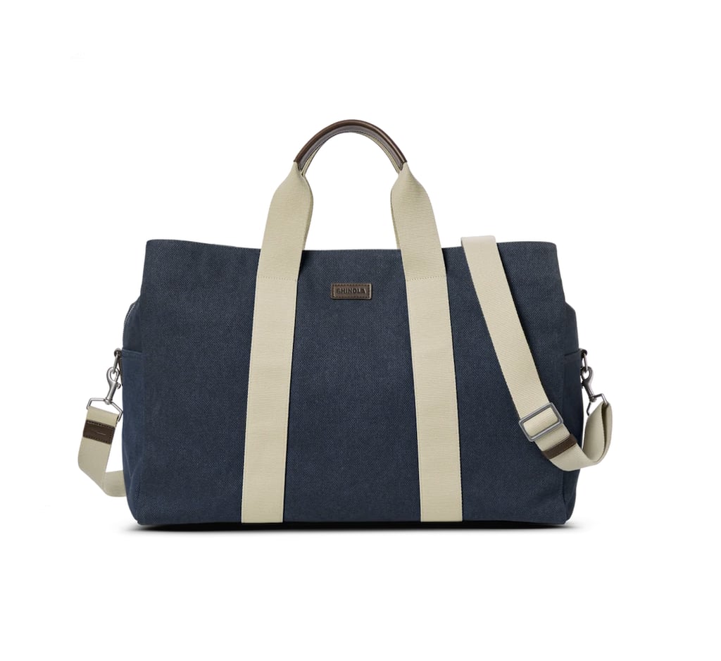 Shinola Canvas Duffle ($595)
Ask any chronic over-packer and they will tell you that the key to getting the most out of a travel bag is a cotton exterior for a little more stretch. This luxury bag has a generous middle pocket for maximum storage and two snap pockets on either side for easy to grab items. Dual straps (with leather accents) offer multiple ways to carry your bag, including an adjustable shoulder band. Consider this Shinola the perfect option for the regular traveler who wants a duffle bag that can last them for years to come. 
Pros: The multi-purpose design makes it the perfect grab and go bag for any type of travel.
Material: Heavyweight cotton.
Dimensions: 14" height x 20" width x 7.5" depth
Colorways: 1
Who it's best for: Someone looking for an investment piece of luggage.