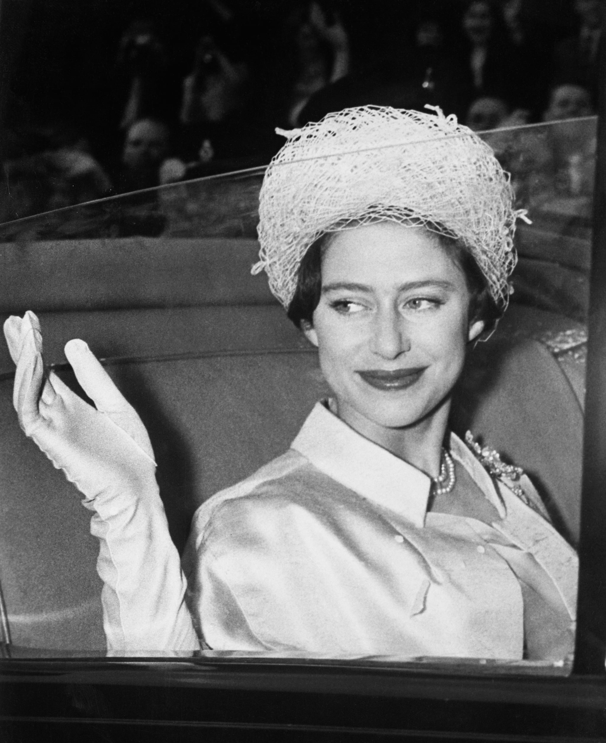(Original Caption) Princess Margaret waves from her coach at Buckingham Palace here May 6th as she leaves on her honeymoon with Antony Armstrong-Jones.