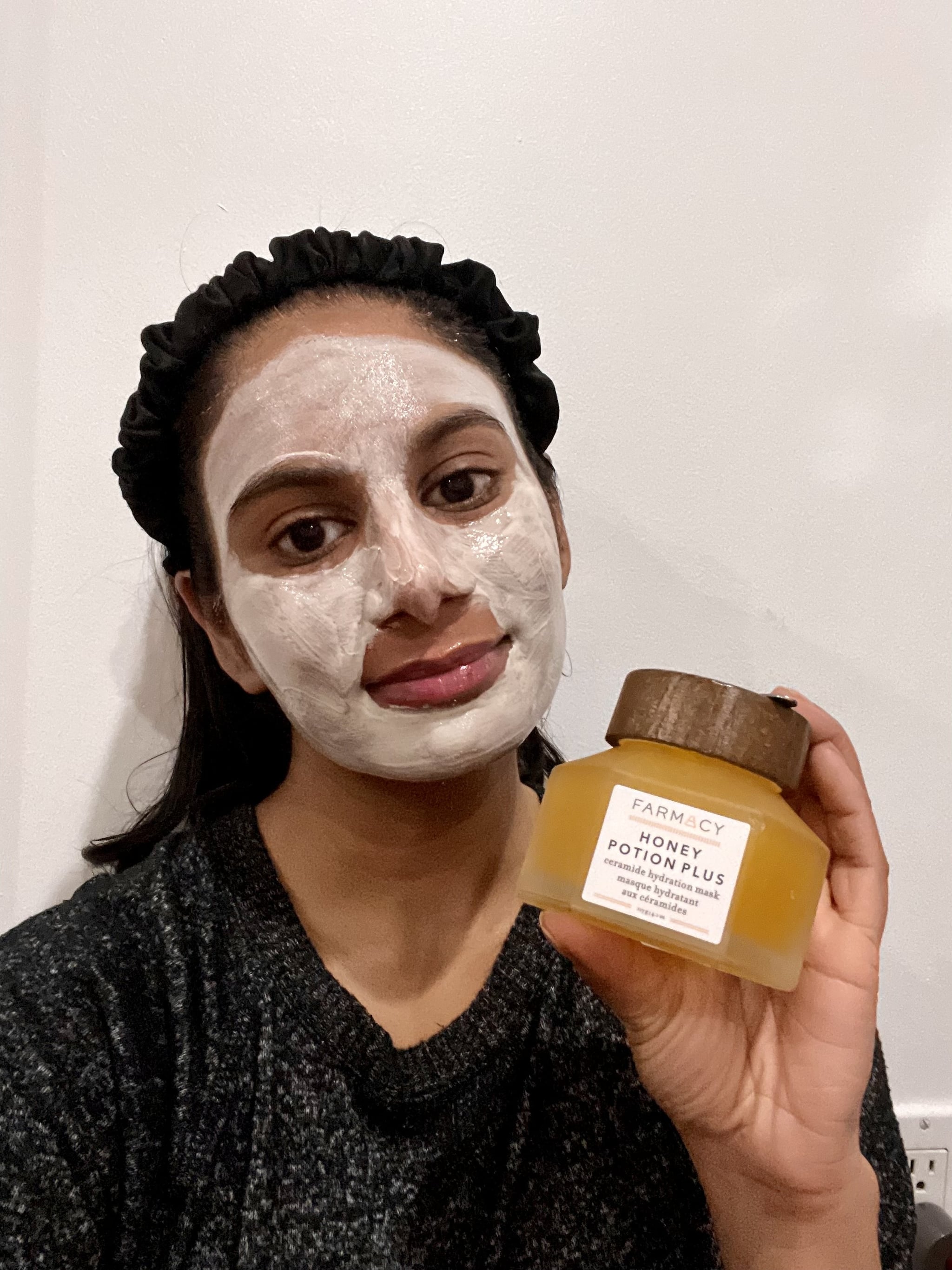 woman using the Farmacy Honey Potion Plus Ceramide Hydration Mask on her skin.