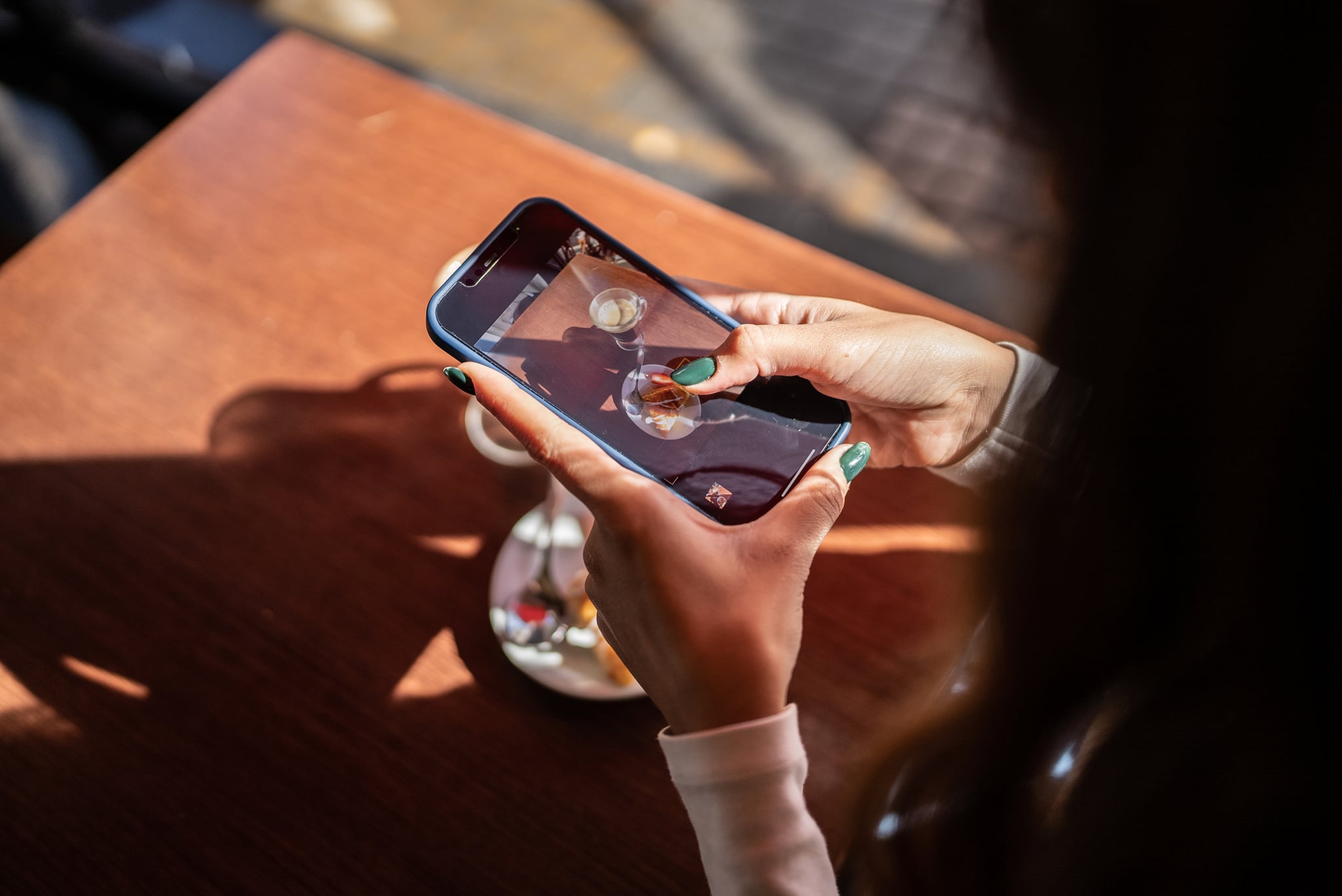 Woman's hand photographing her fodd and drink in a cafeteria