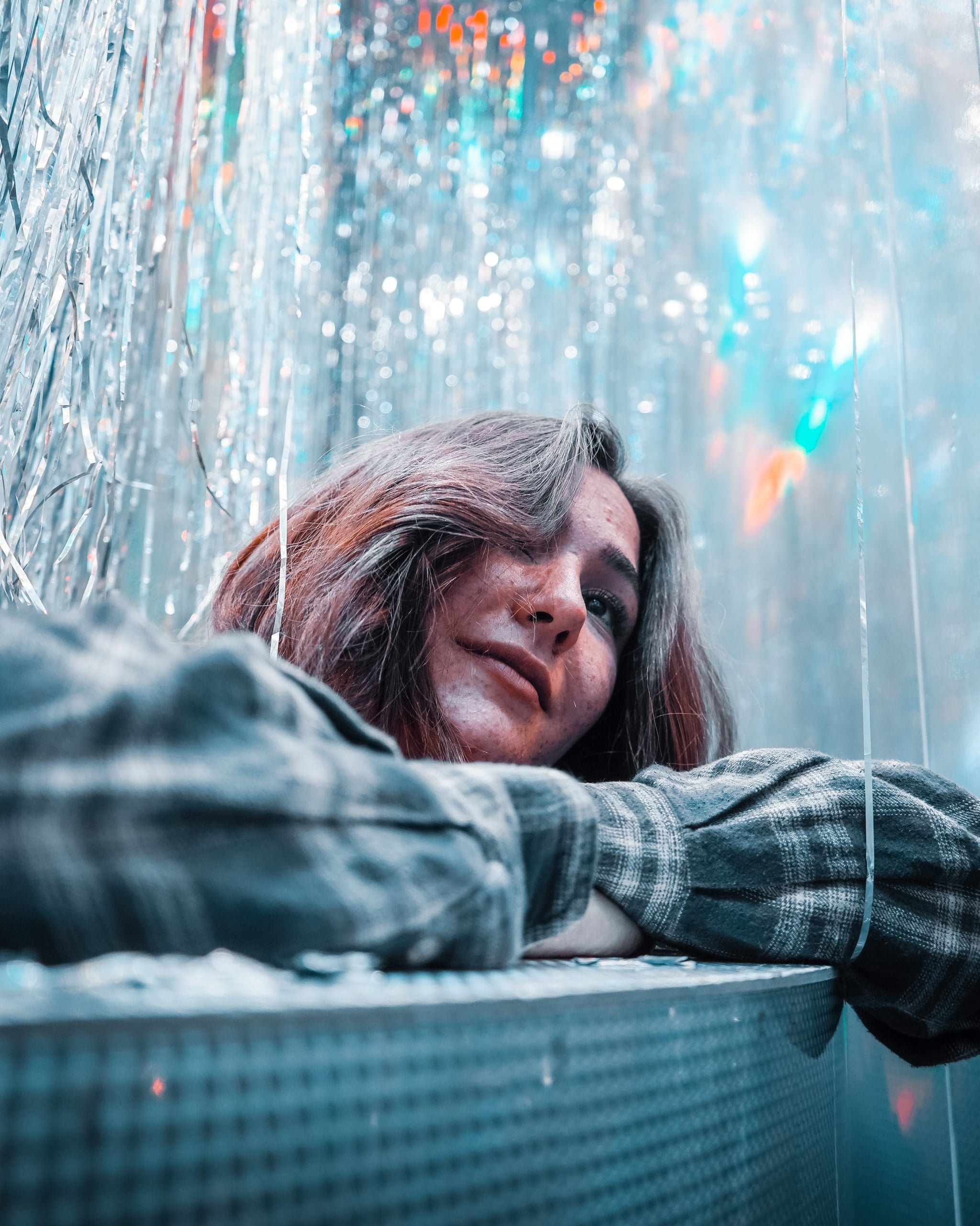 person with long hair surrounded by silver glitter as representative of dreamy Pisces new moon