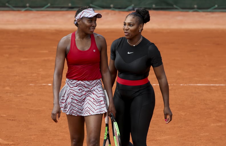 PARIS, FRANCE - MAY 30: Serena Williams and Venus Williams (with a cap) of USA during Day Four of the 2018 French Open at Roland Garros on May 30, 2018 in Paris, France. (Photo by Jean Catuffe/Getty Images)