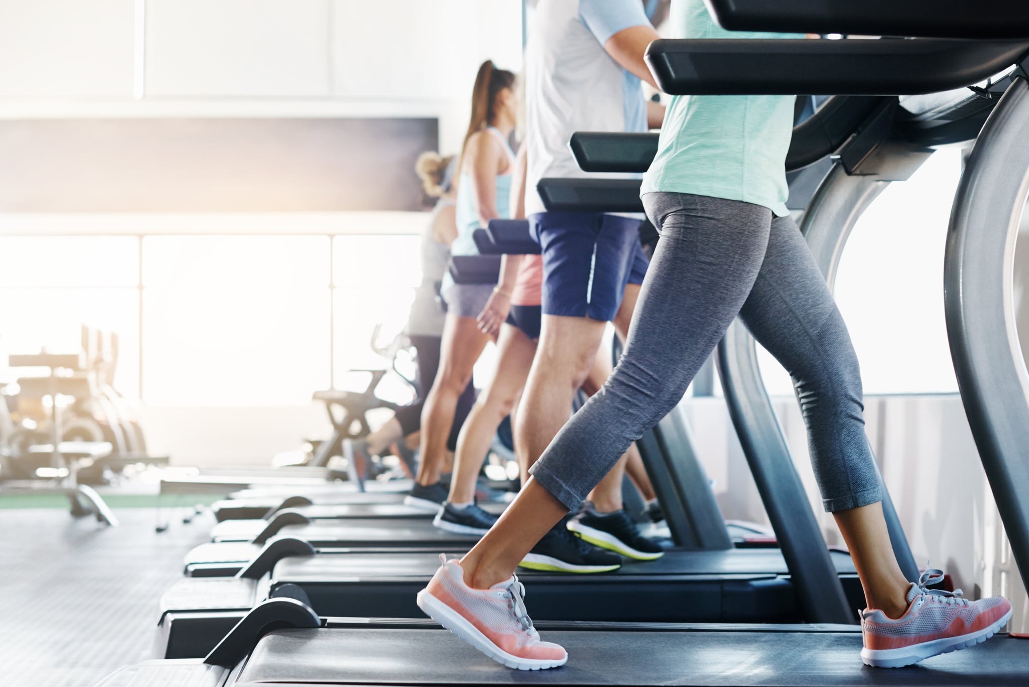 Cropped shot of a group of people exercising on treadmills in a gym