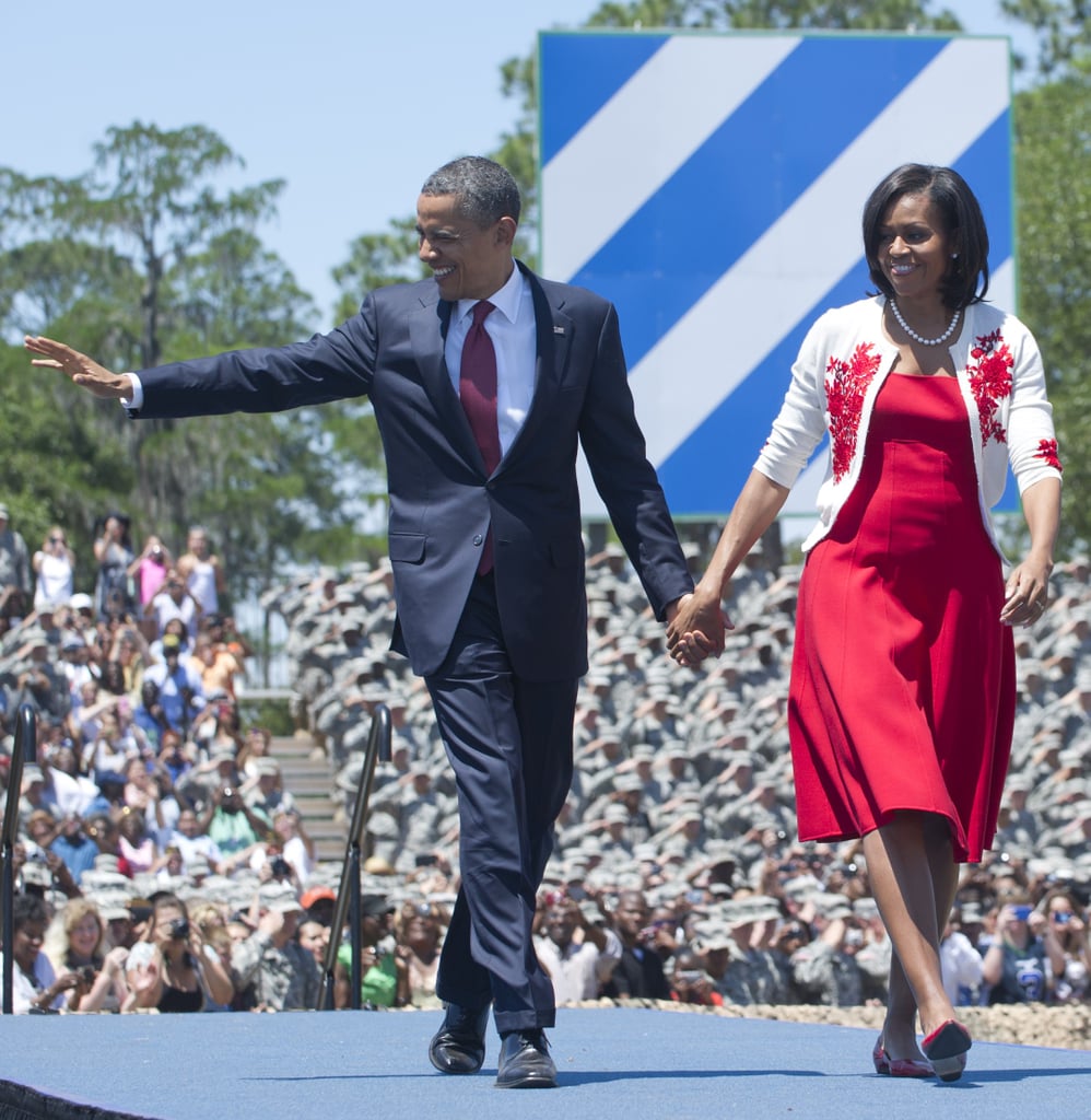 During a visit to the US troops in 2012, Michelle covered up her red dress with an embroidered L'Wren Scott cardigan.