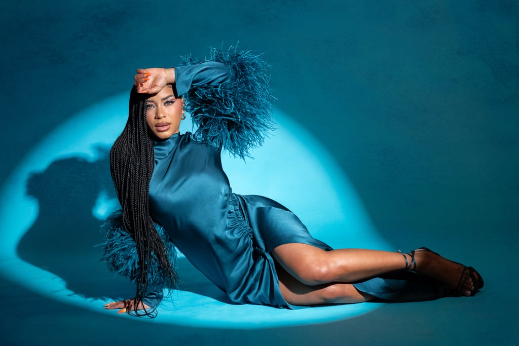 For the grand finale of Espinal's shoot and the cover look, it should come as no surprise that she leaned into a statement gown. Swathed in satin and feathers wearing Lapointe's Satin Tab Gown ($2,450) in dark teal, she showed a stripped-back side of herself that evoked a sense of vulnerability and power at the same time. Rembert added matching Jimmy Choo sandals and a Le Vian Couture opal ring ($13,048) to accessorize and Wagenblast opted for a sleek, sculpted matte eye teamed with glowing skin and defined liner.
You could call this gown a glamorous version of the green muumuu she wore in episode 28, which she picked up in Portugal. "Bringing that piece back to the villa reminded me of my travels and reminded me of the good days whenever I was having a bad one," she said in an interview with the Today show. "It was more than a dress for sure — it really made me feel grounded." In our opinion, this was Espinal's editorialized moment of grounding, and in this gown, her inimitable glow shines through.
Get the look: Asos Design Curve Kimono Sleeves Cape Detail Draped Midaxi Dress ($85). Coast Feather Trim Satin Maxi Dress ($129, originally $258). Club L London Adella Light Green Satin Feather-Trim Maxi Dress ($225). Bronx and Banco Geisha V-neck Gown ($1,100). Lapointe Satin Tab Gown in Slate ($1,750). Ana Luisa Guilia Medium Hoop Earrings ($65). Jenny Bird Medium Staple Hoops ($108). MissHeel Soft Padded Metallic Lace Up High Heel Sandals ($40). Jeffrey Campbell Obsessed Satin Strappy Ankle Wrap Dress Sandals ($40, originally $160). Paulie Designs Jewelry Coffin Black Fire Opal Engagement Ring ($81, originally $108). MyBlackOpal Copper Ring With Australian Opal ($167). Shades by Shan The Liquid Blush in Glowing Guava ($22). Make Up For Ever Artist Color Pencil Long-Lasting Lip Liner in Dimensional Brown ($25). Patrick Ta Major Headlines Double-Take Blush Duo in She's Blushing ($38). Patrick Ta Major Dimension III Matte Eyeshadow Palette ($70).