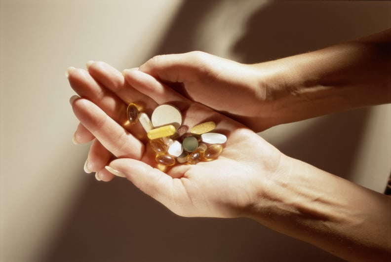 Handful of assorted supplements for stress.