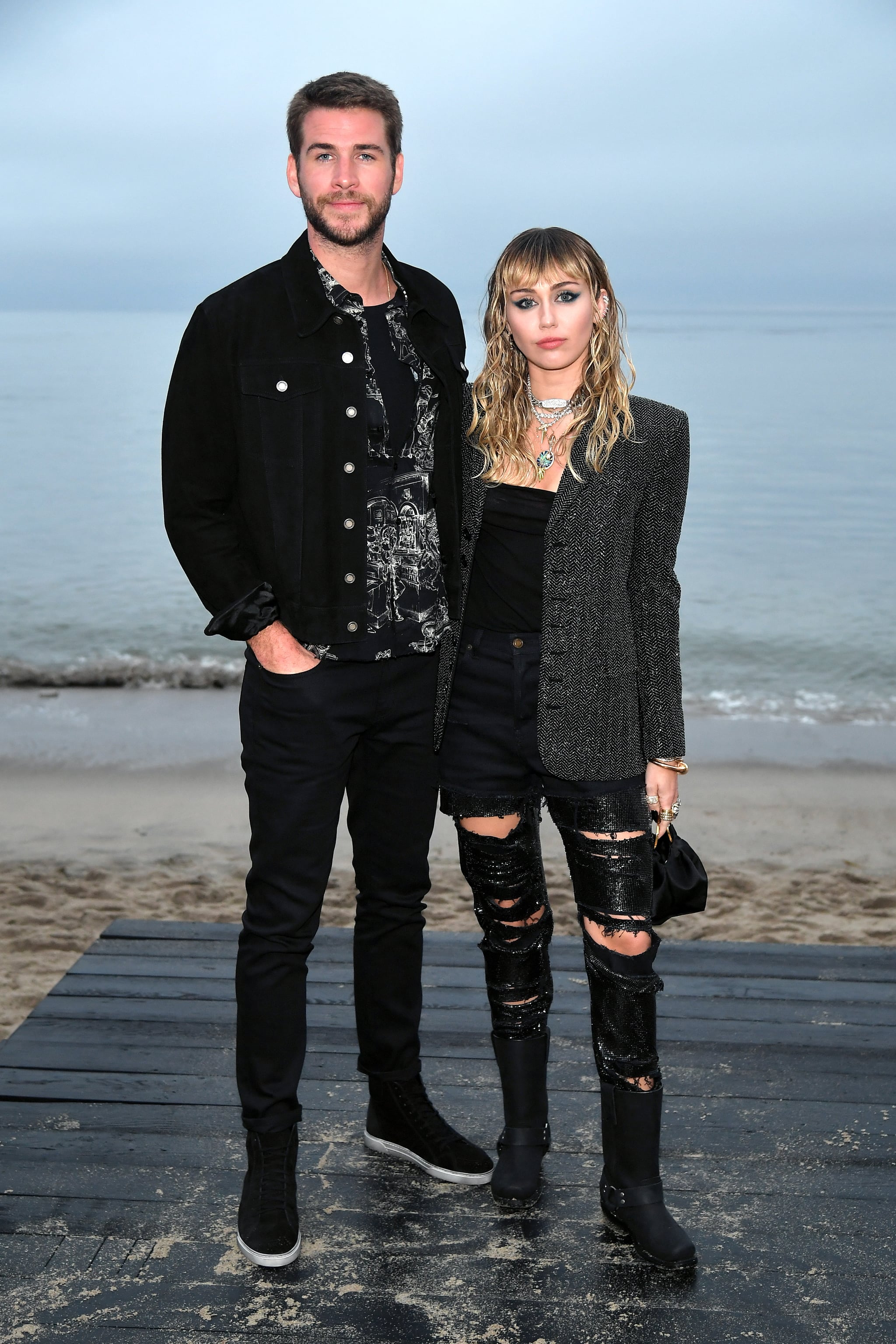 MALIBU, CALIFORNIA - JUNE 06: (L-R) Liam Hemsworth and Miley Cyrus attend the Saint Laurent Mens Spring Summer 20 Show on June 06, 2019 in Paradise Cove Malibu, California. (Photo by Neilson Barnard/Getty Images)