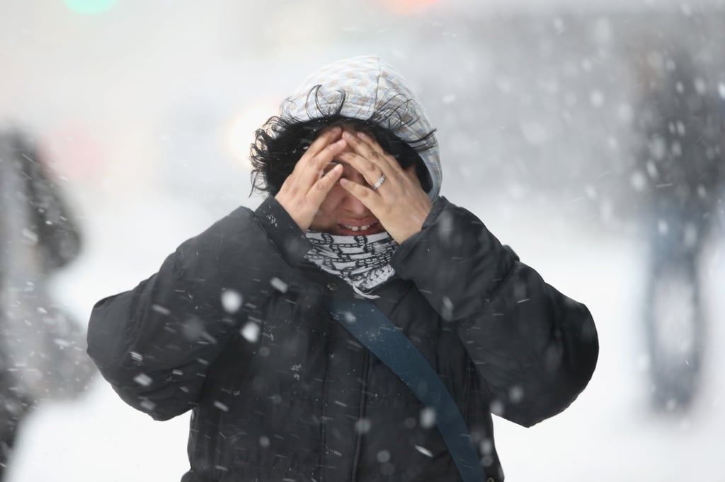 One woman covered her face as she walked through the snow in NYC.