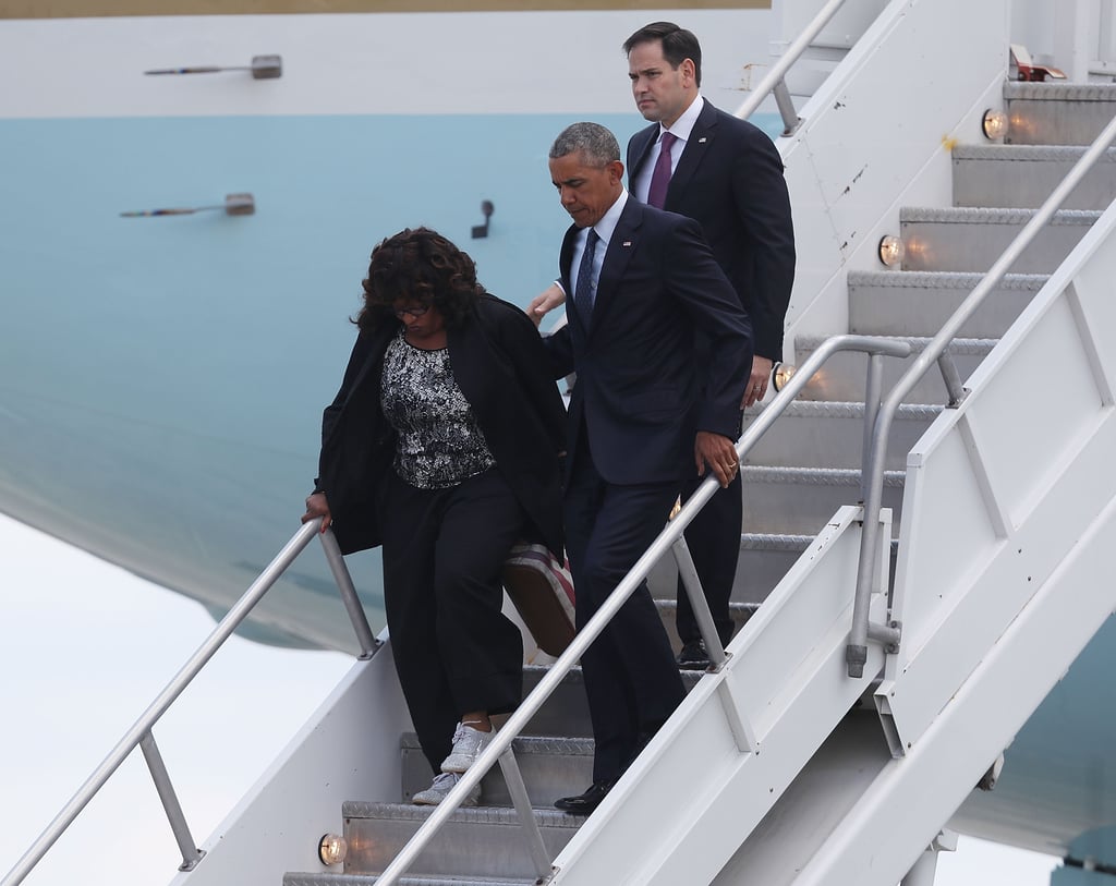 Florida Democratic Representative Corrine Brown and Florida Republican Senator Marco Rubio walk with President Obama after he lands at the Orlando International Airport.