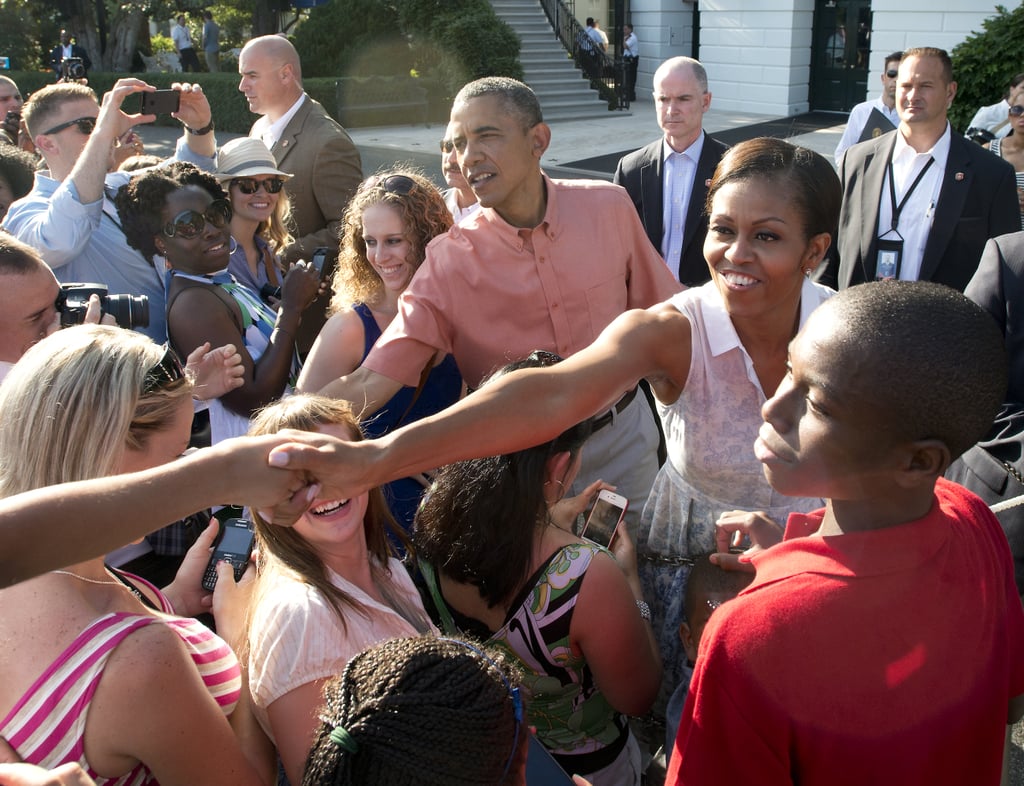 President Obama and First Lady Michelle greeted the crowd during the White House Fourth of July BBQ honoring military families in 2013.