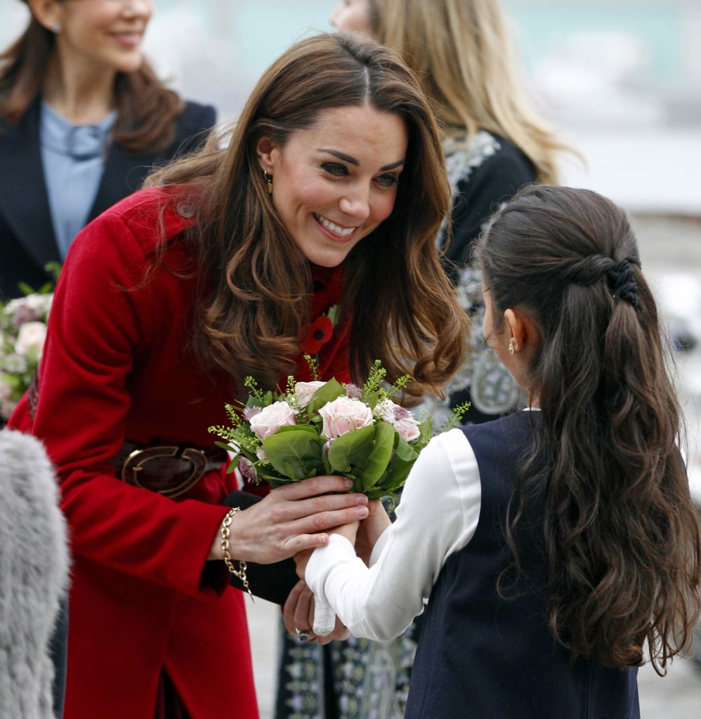 Kate smiled at a little girl during a UNICEF visit in Denmark in November 2011.