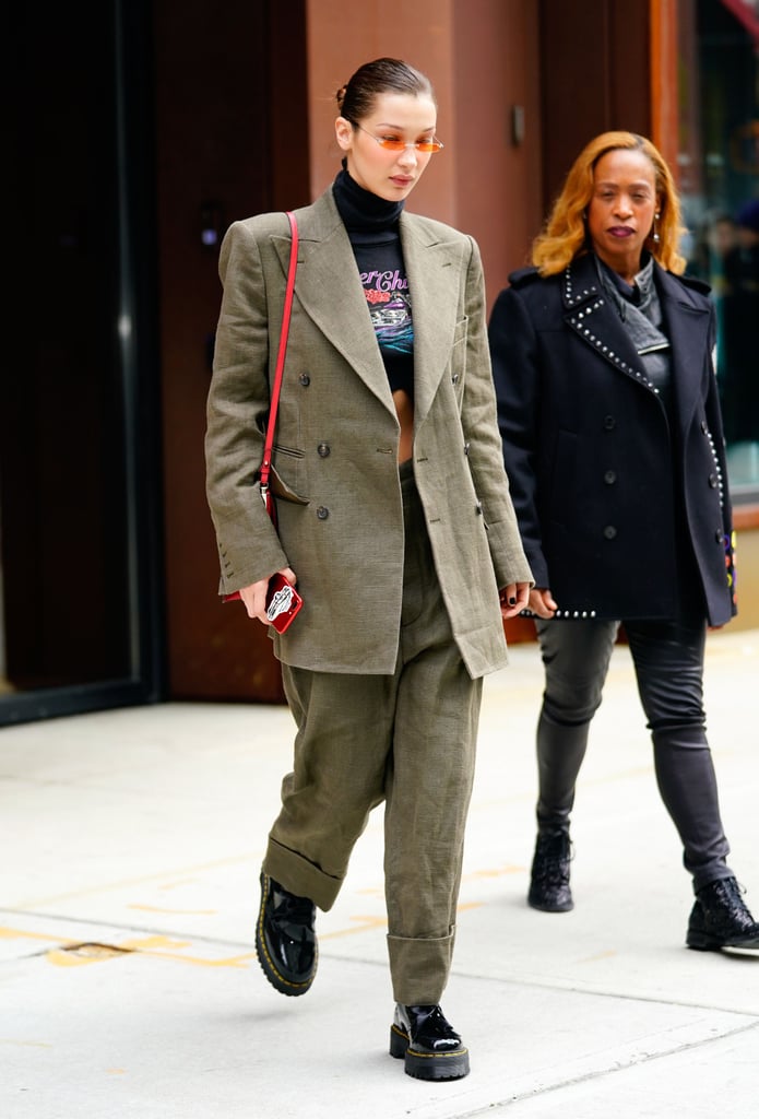 Wearing an oversize plaid suit with a turtleneck tee that had the phrase "Rocker Chic" written on it. She styled her look with Dr. Martens boots and a Prada bag.