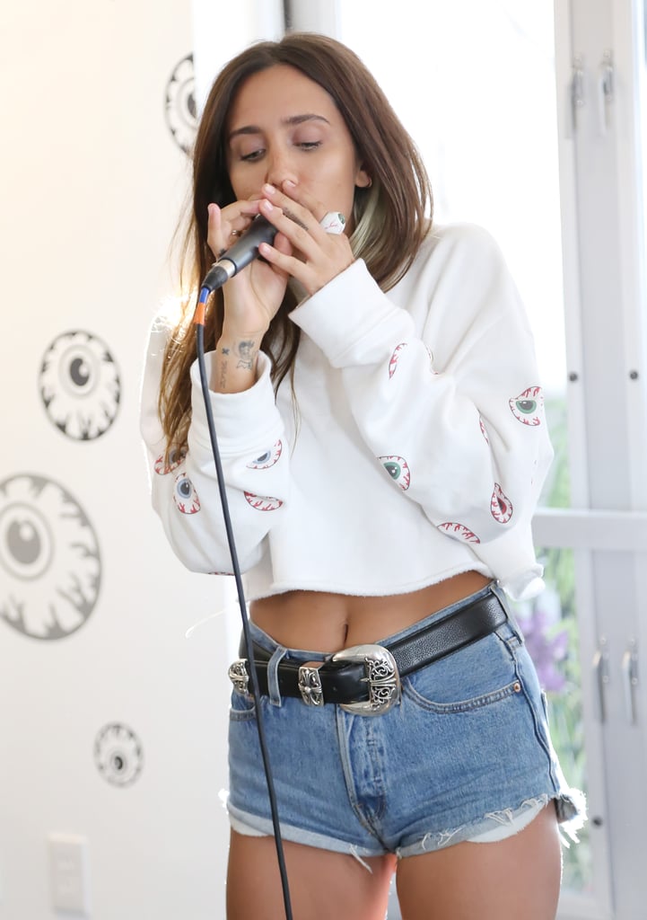 In Her Go-To Outfit of a Sweatshirt and Denim Cutoffs