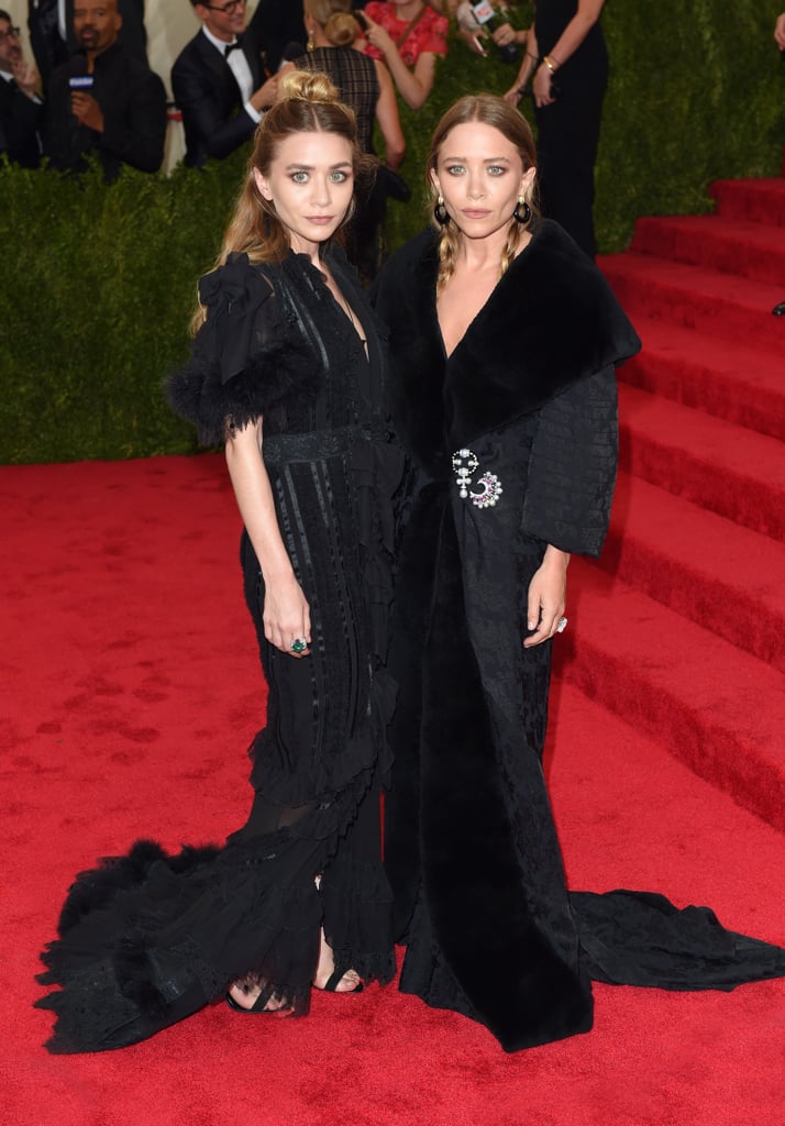 Twinning combo: M-K and A brought the drama in all black at the 2015 Met Gala.

Ashley looked glamorous in a Victorian-inspired style.
Mary-Kate pinned shimmering brooches on her luxe coatdress.