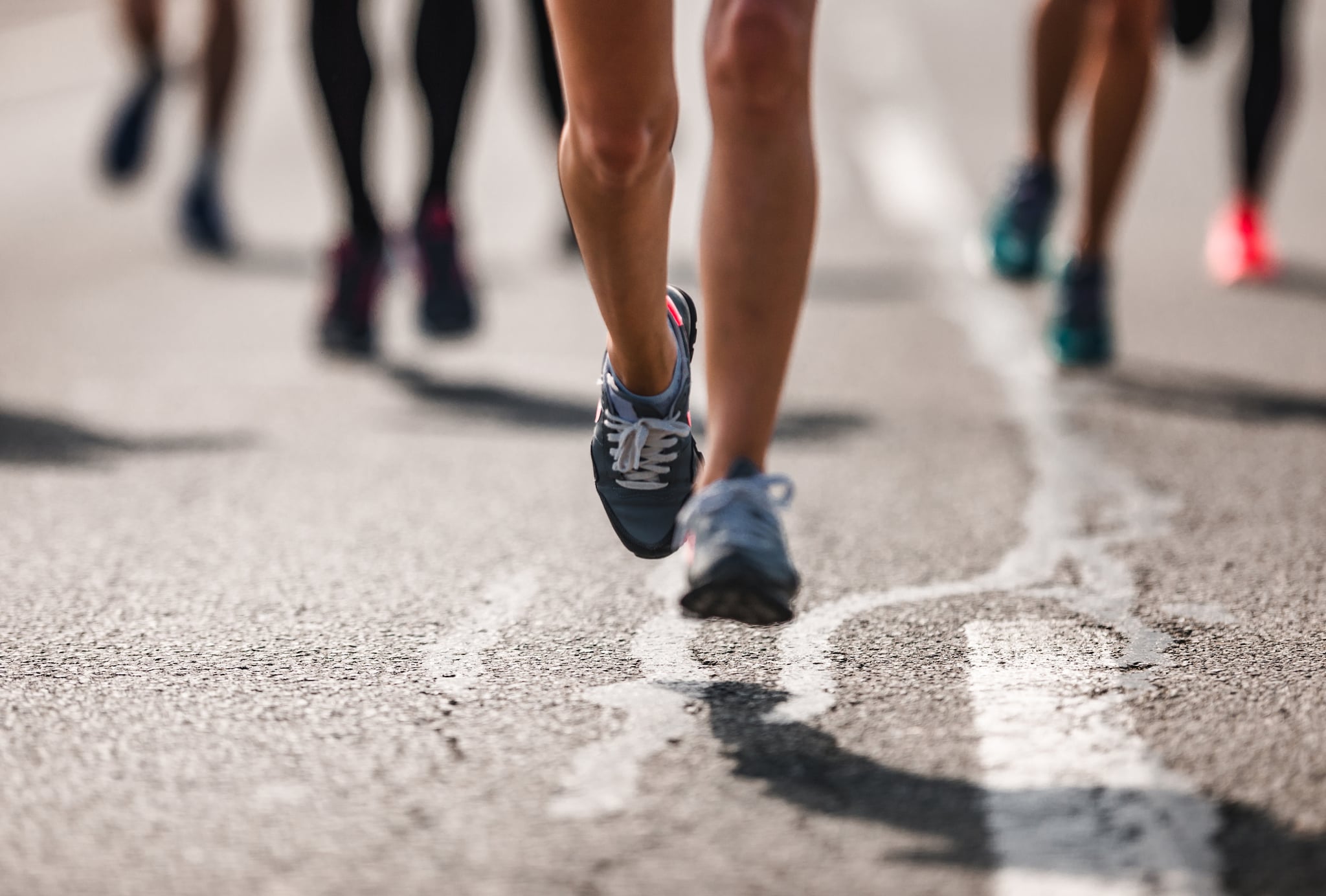 Unrecognisable marathon runner having a race on the road.