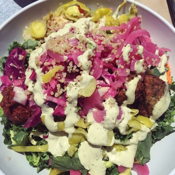 Make your own falafel salad by pairing your greens with popular toppings like pickled onions, tomatoes, cucumbers, hummus, and tahini. 
Source: Instagram user tenderlovingvegan