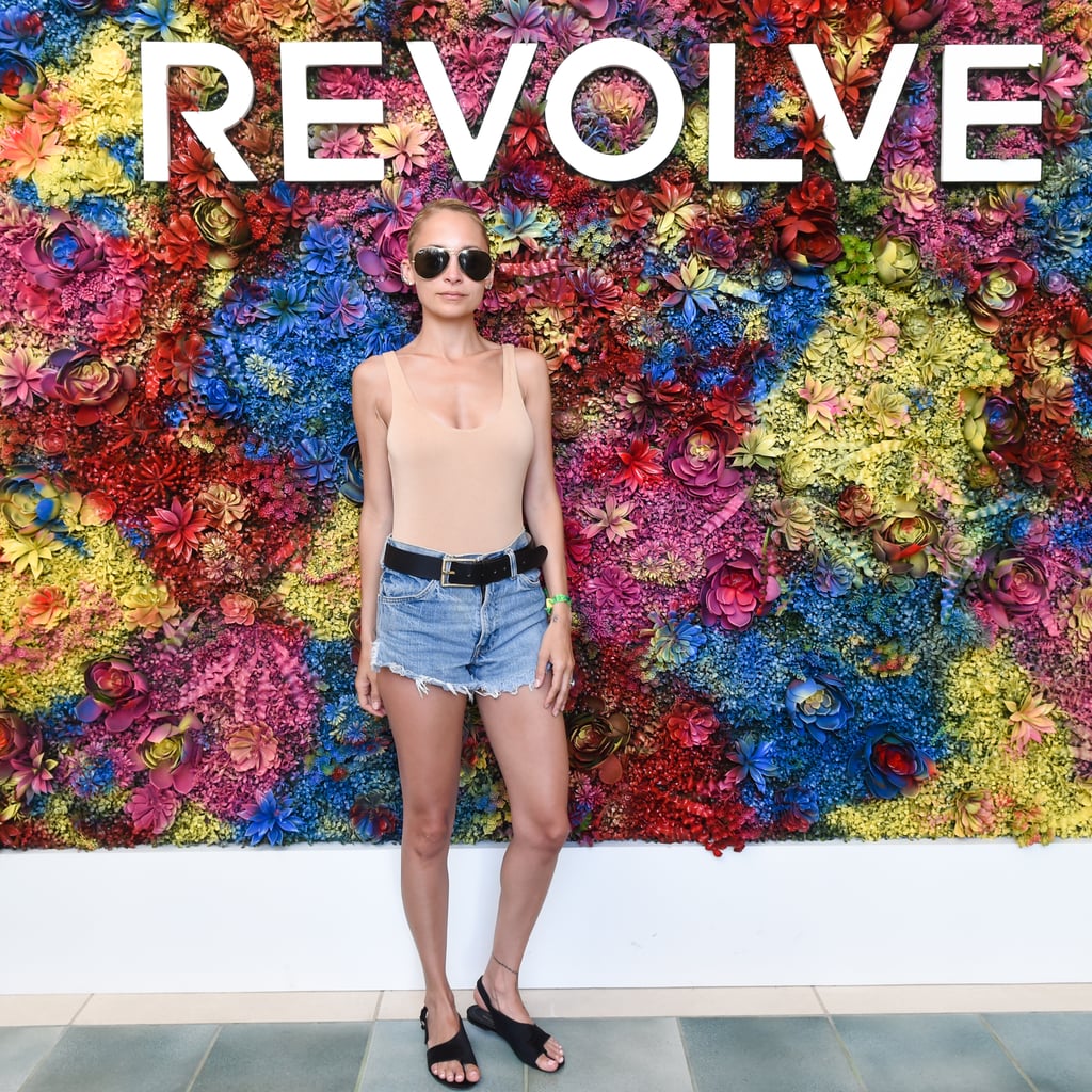 Nicole Richie wearing a sleek tank, denim shorts, and flat sandals at the Revolve Festival party. 