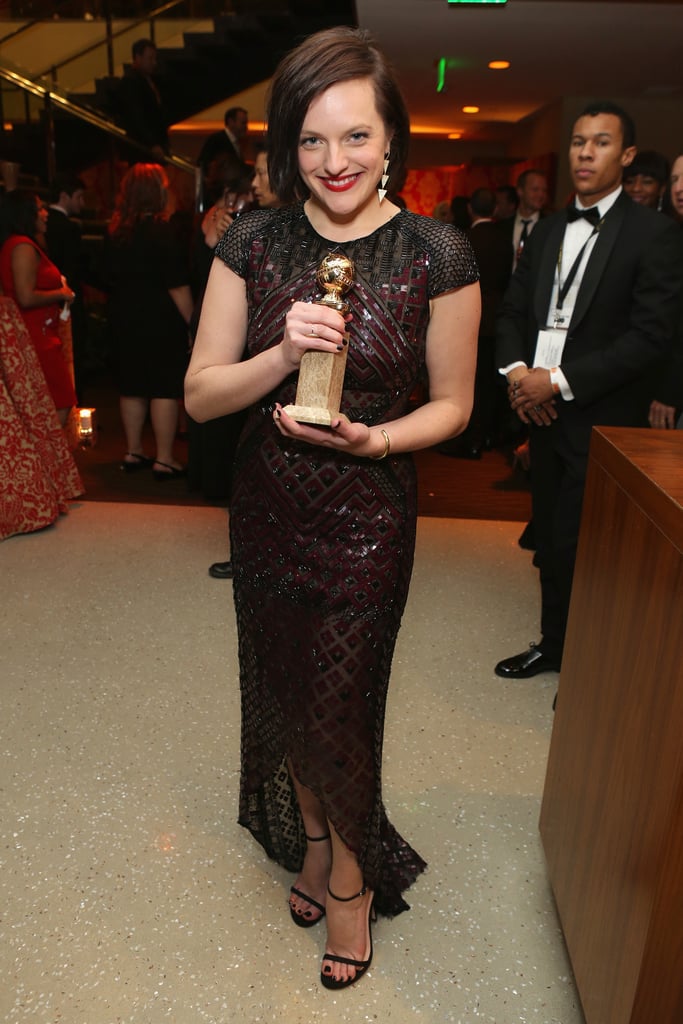 Elisabeth Moss showed off her Golden Globe.