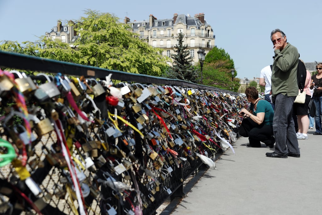 People looked at the love locks on the Archeveche bridge in Paris.