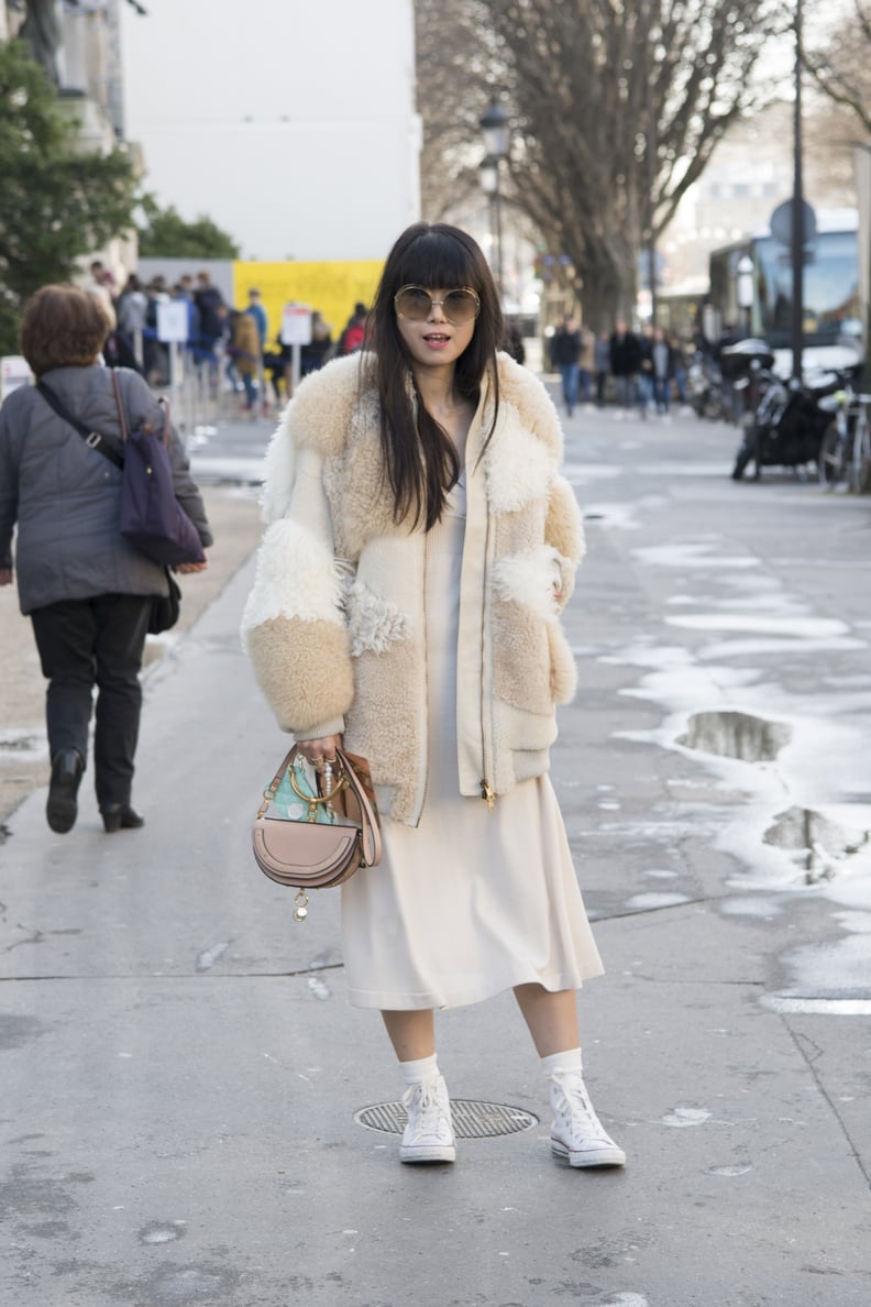 With a White Dress and a Cream-Colored Coat