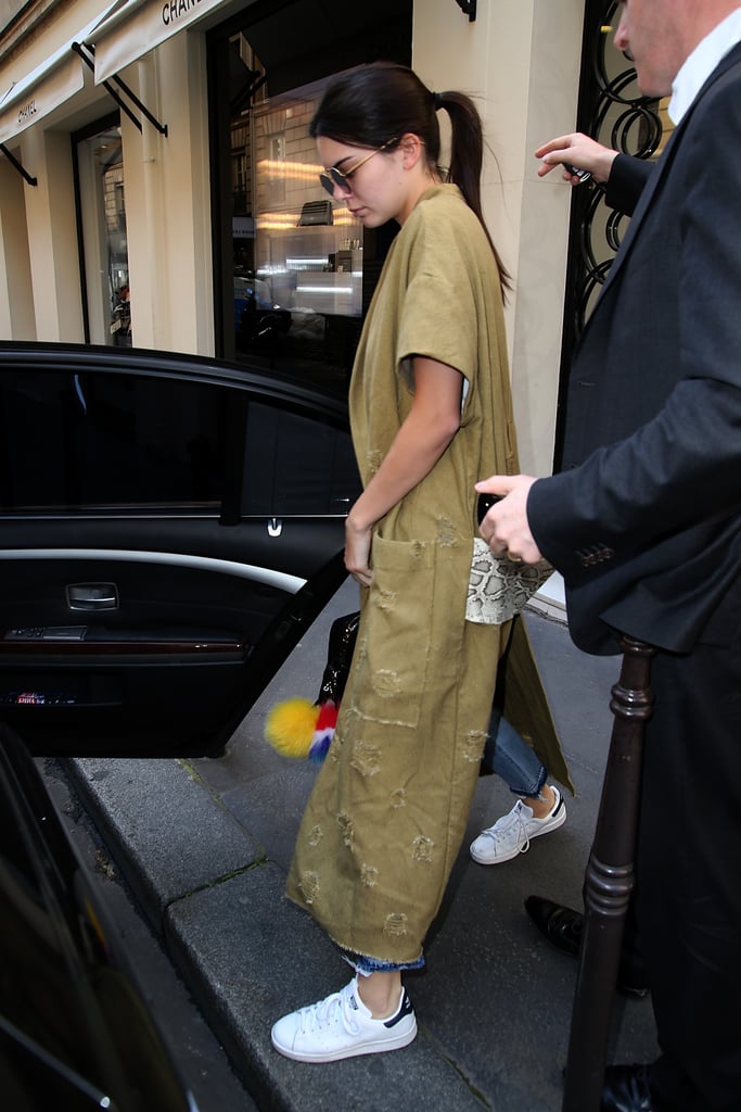 Later, Kendall showed off a distresed robe style with oversize pockets, letting it stand out by opting for denim and a white tee. She finished her outfit with her go-to sneakers and a Givenchy bag.