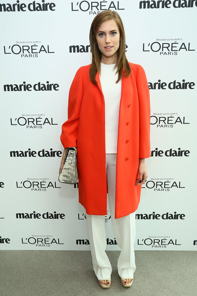 Her all-white separates got a major boost from an oversize clutch and a crisp, neon coat.