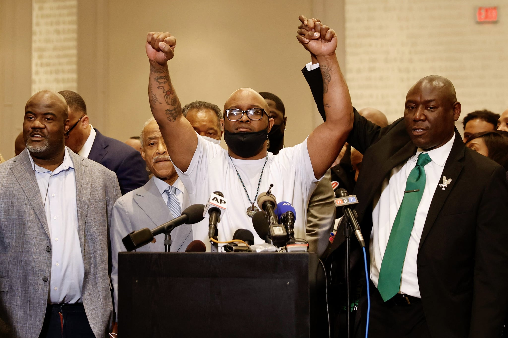 George Floyd's brother Terrence Floyd (C) holds up his hands with family lawyer Ben Crump (R) during a press conference following the verdict in the trial of former police officer Derek Chauvin in Minneapolis, Minnesota on April 20, 2021. - Derek Chauvin, a white former Minneapolis police officer, was convicted on April 20of murdering African-American George Floyd after a racially charged trial that was seen as a pivotal test of police accountability in the United States. (Photo by Kerem YUCEL / AFP) (Photo by KEREM YUCEL/AFP via Getty Images)