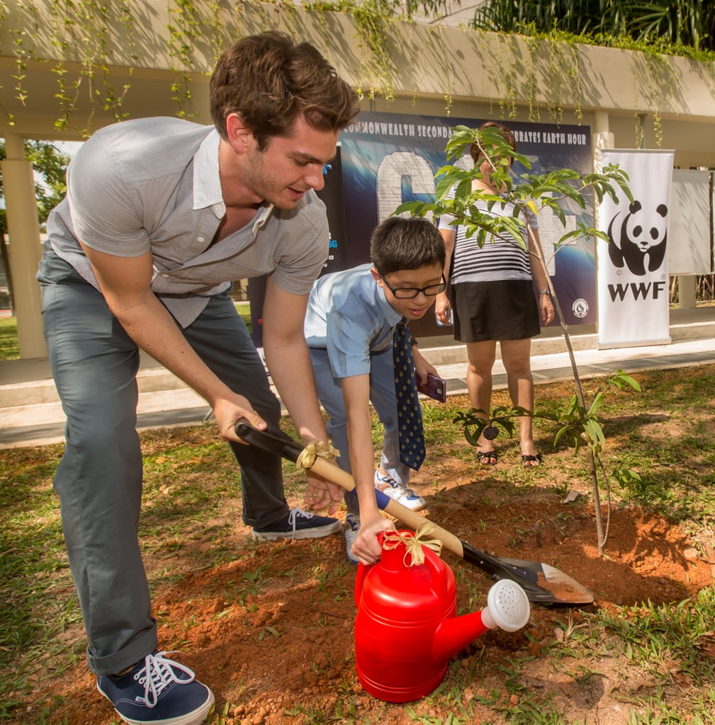 He helped kids plant trees at an environmentally progressive school in Singapore in March 2014.