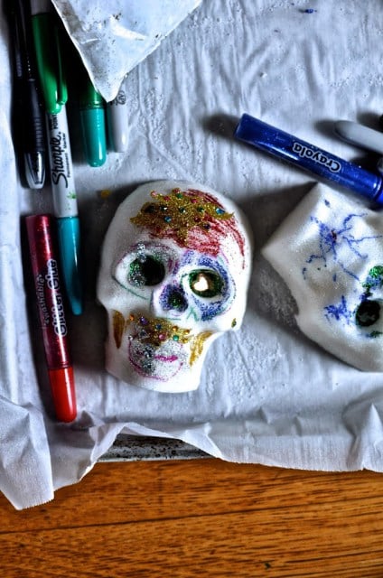 For an easy (and kid-friendly) option, decorate your sugar skulls with (nonedible) glitter and paint pens.