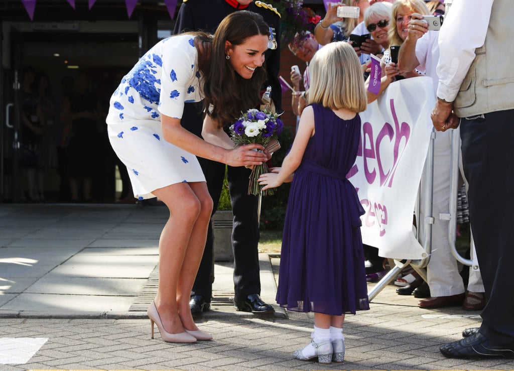 During a visit to London's Keech Hospice Care in August 2016, Kate was greeted by a little girl with flowers.