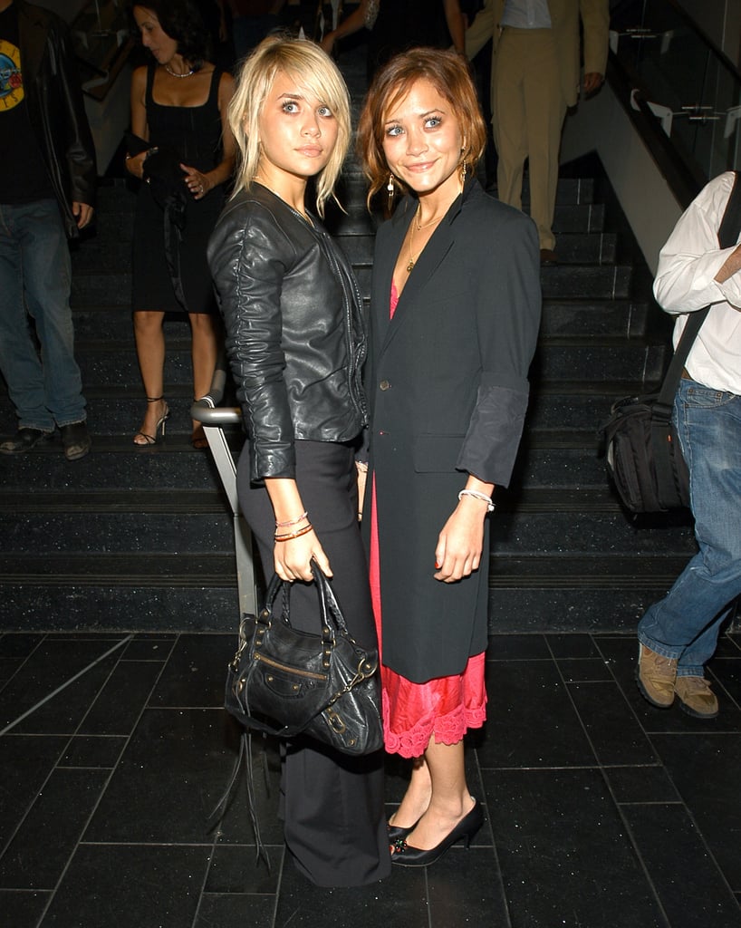 Twinning combo: Both girls fused feminine separates with a dash of menswear flair at Coty's 100th anniversary celebration in New York City.

Ashley's supple leather jacket roughed up her sweet updo and fitted black trousers.
Mary-Kate cuffed a long black coat over a red, lace-trim slip dress.
